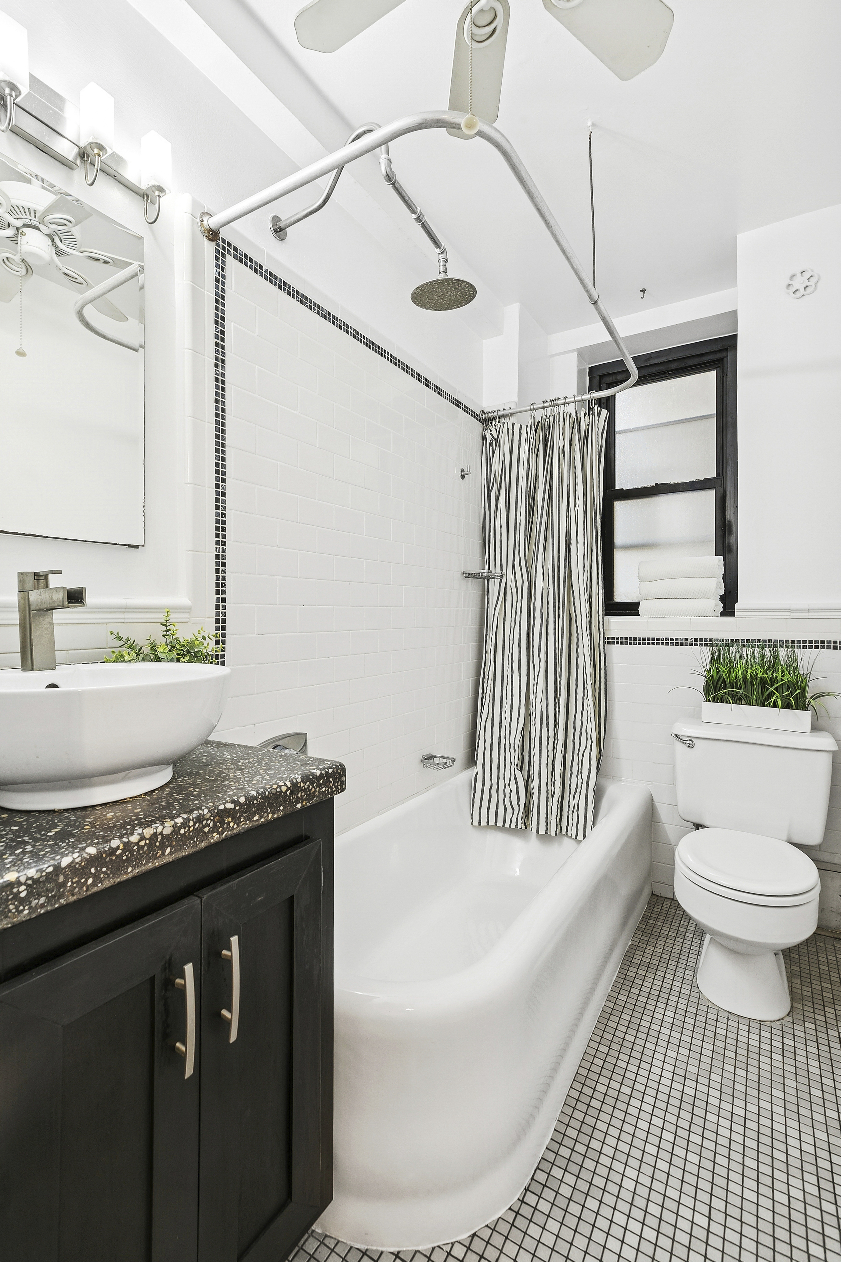235 East 22nd Street, Unit 4M Manhattan, NY 10010 - Photo 6 of 14 a bathroom with a granite countertop sink a toilet a mirror and bathtub