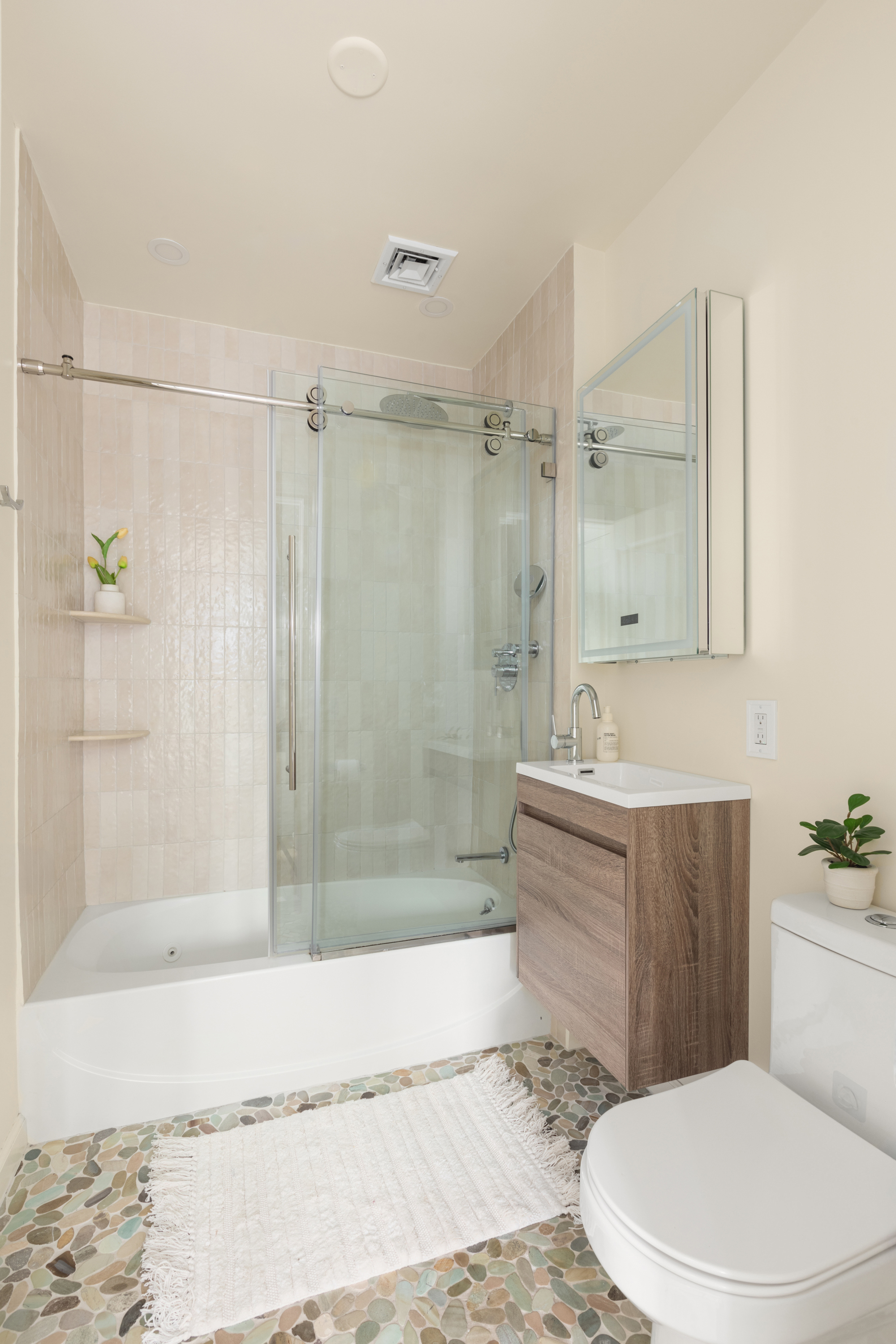61 Lenox Avenue, Unit 5D Manhattan, NY 10026 - Photo 9 of 14 a bathroom with a sink a toilet and shower