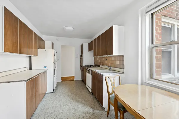 a kitchen with a stove a refrigerator and a sink