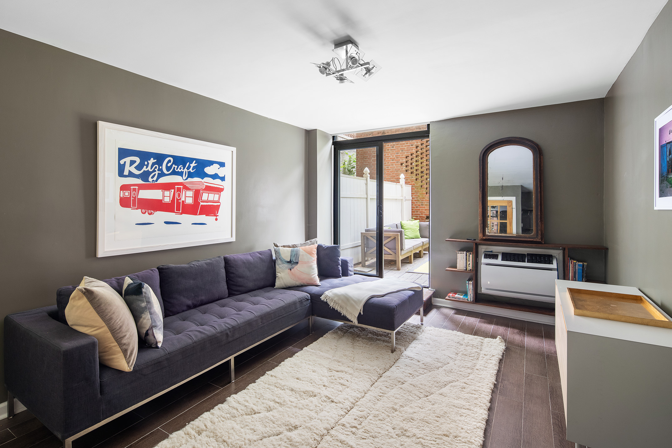 435 East 86th Street, Unit GB Manhattan, NY 10028 - Photo 1 of 11 a living room with furniture and a large window