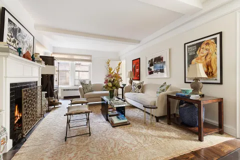 a living room with furniture a fireplace and a window