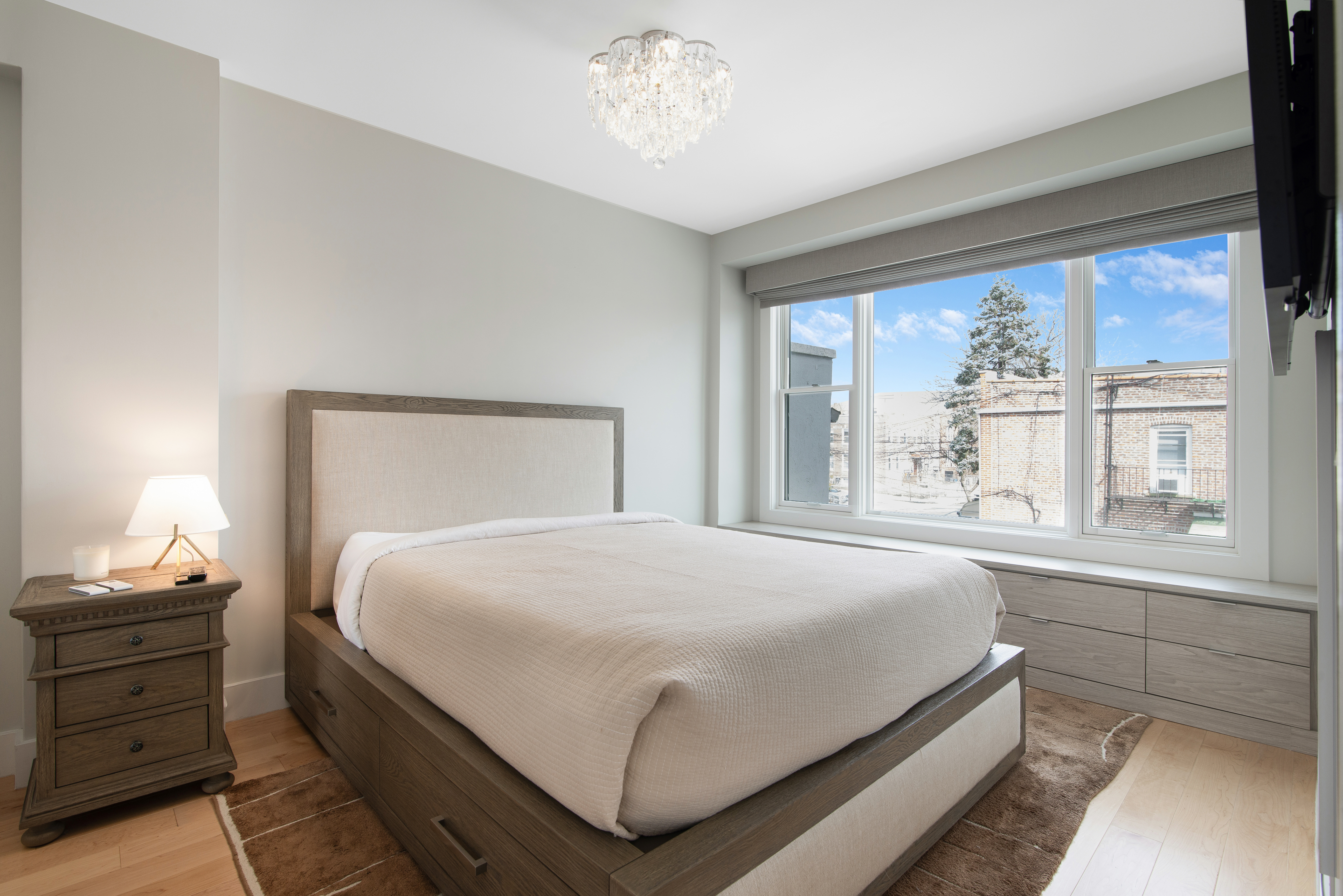 23-05 24th Avenue, Unit 3B Queens, NY 11102 - Photo 5 of 10 a bedroom with a bed and a window