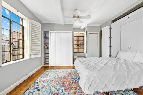 a spacious bedroom with a bed and a window