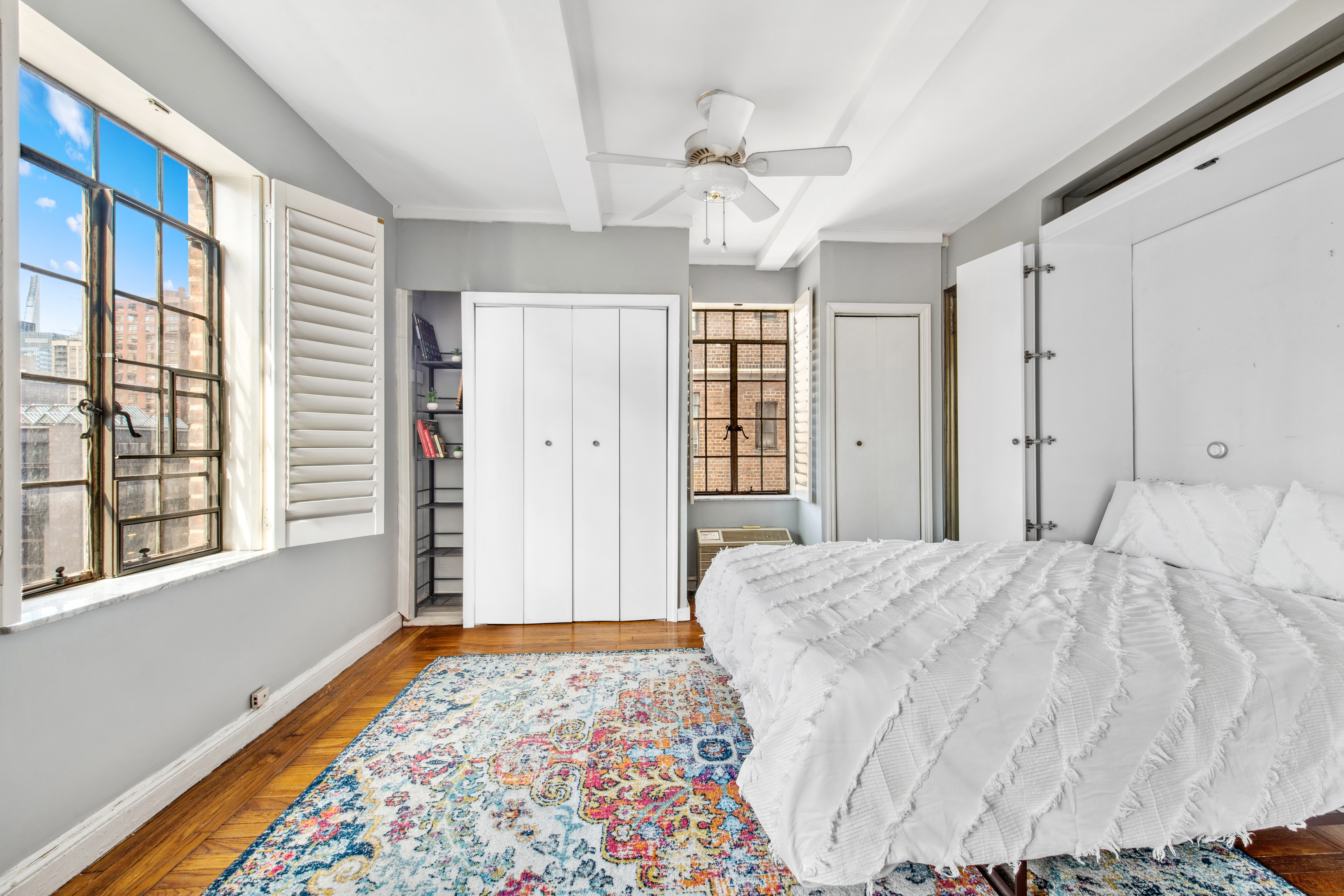 25 Tudor City Place, Unit 1419 Manhattan, NY 10017 - Photo 5 of 14 a spacious bedroom with a bed and a window