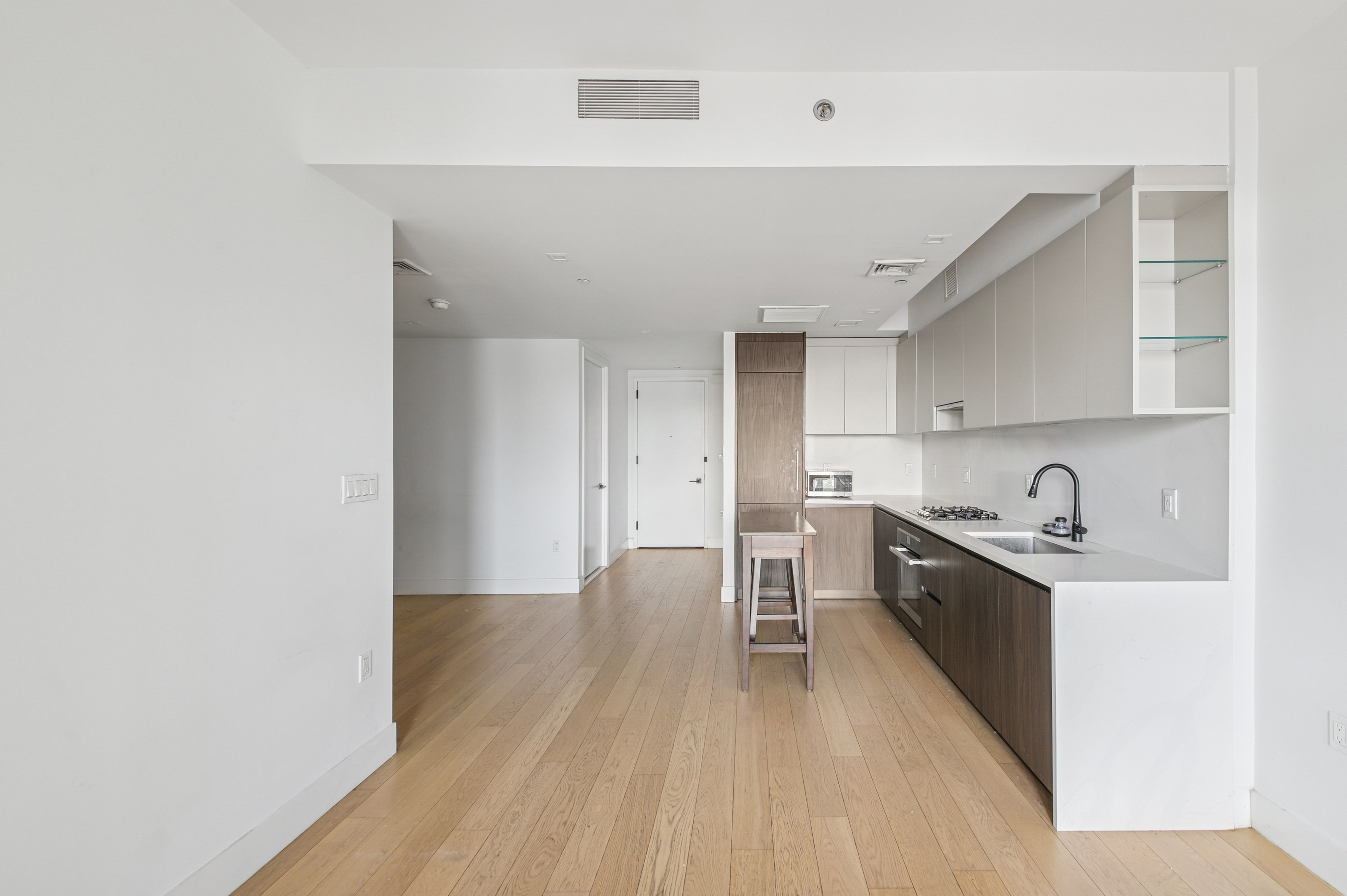 11 Hancock Place, Unit 1003 Manhattan, NY 10027 - Photo 2 of 13 a kitchen with granite countertop a stove a sink and a refrigerator