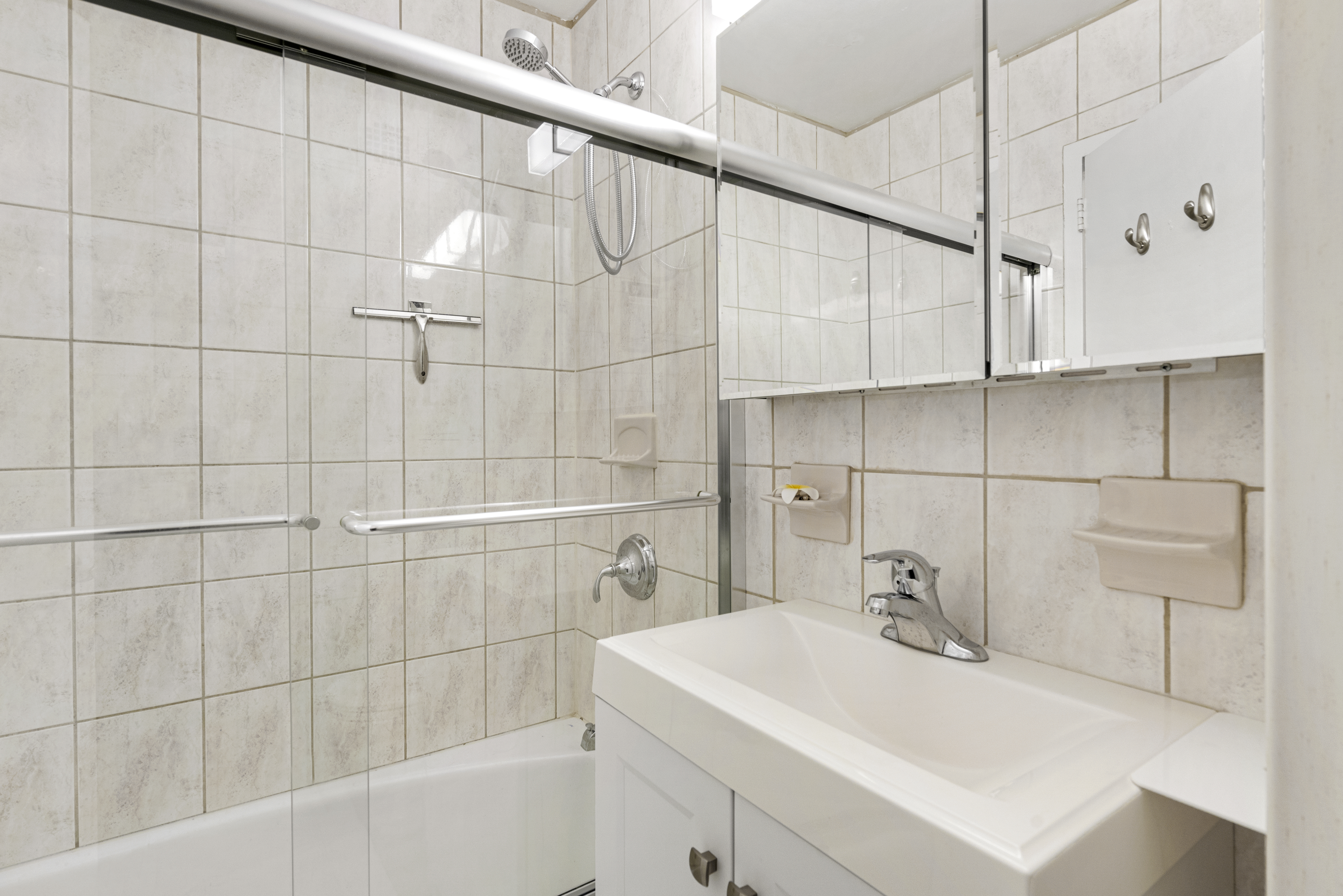 1160 3rd Avenue, Unit 15F Manhattan, NY 10065 - Photo 7 of 8 a bathroom with a sink and shower