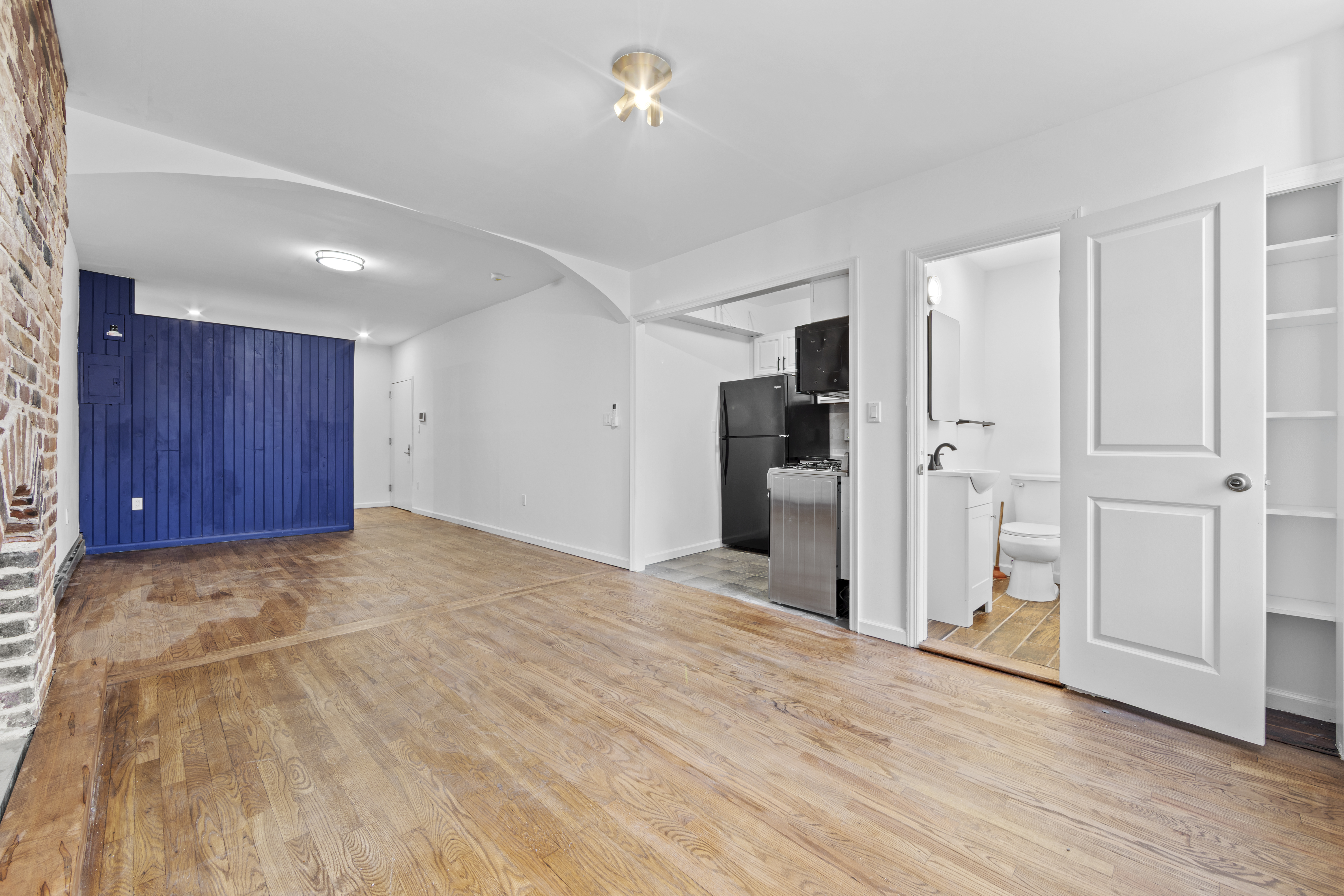 1061 Fulton Street, Unit 3 Brooklyn, NY 11238 - Photo 5 of 14 a view of an empty room with wooden floor and entryway