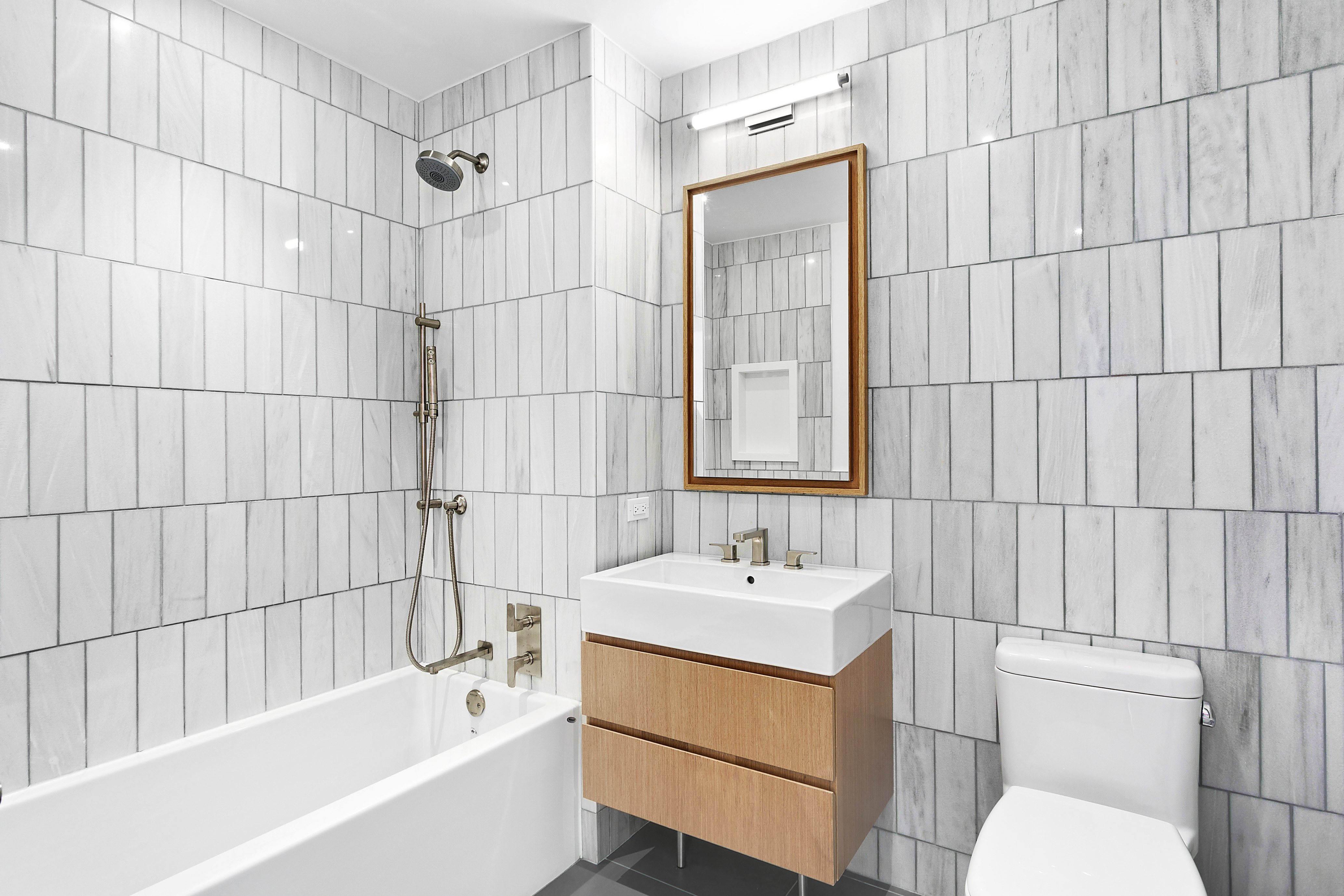 21-30 44th Drive, Unit 2D Queens, NY 11101 - Photo 2 of 6 a bathroom with a sink toilet and shower