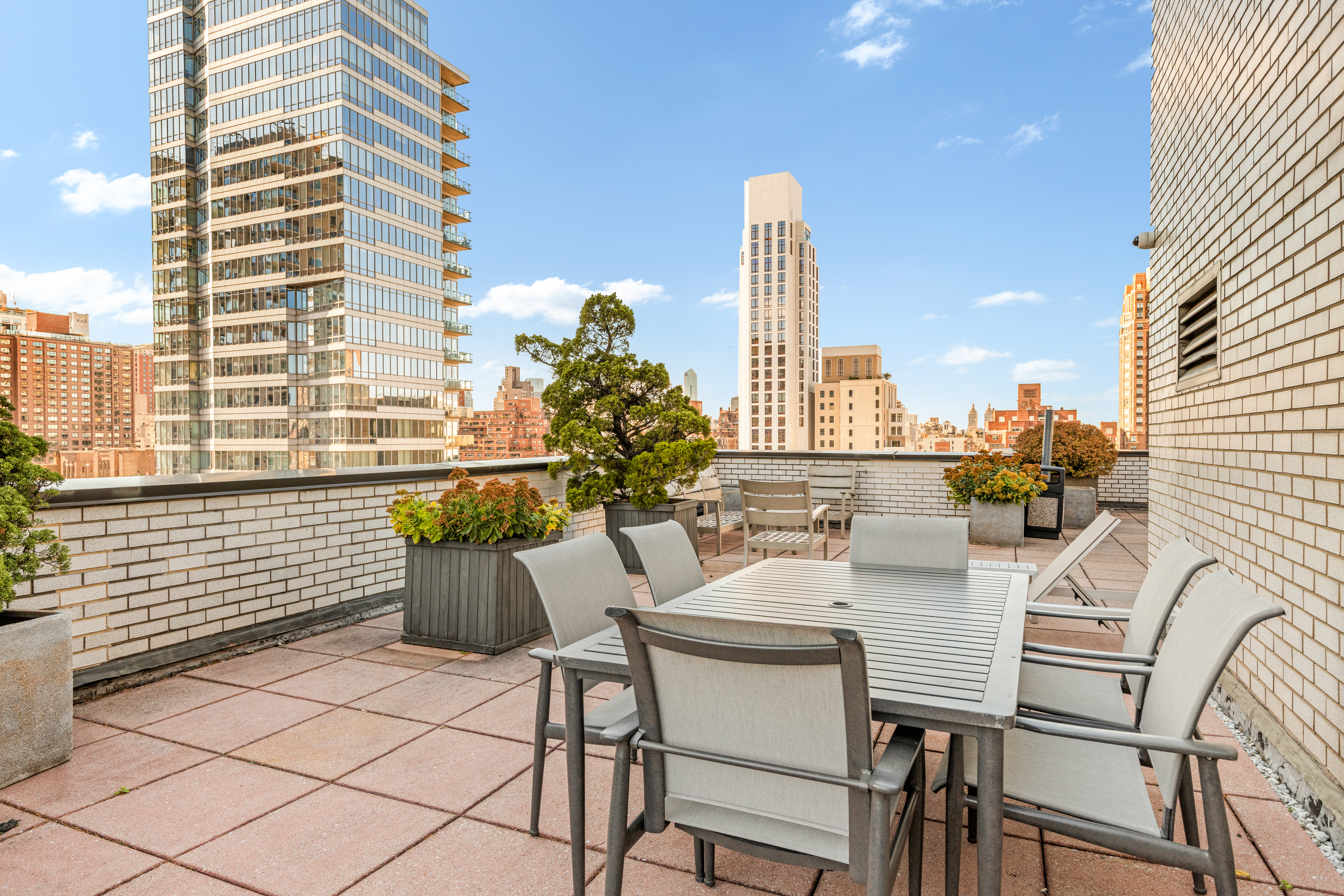 301 East 75th Street, Unit 14J Manhattan, NY 10021 - Photo 5 of 8 a view of a city from a dining room with furniture