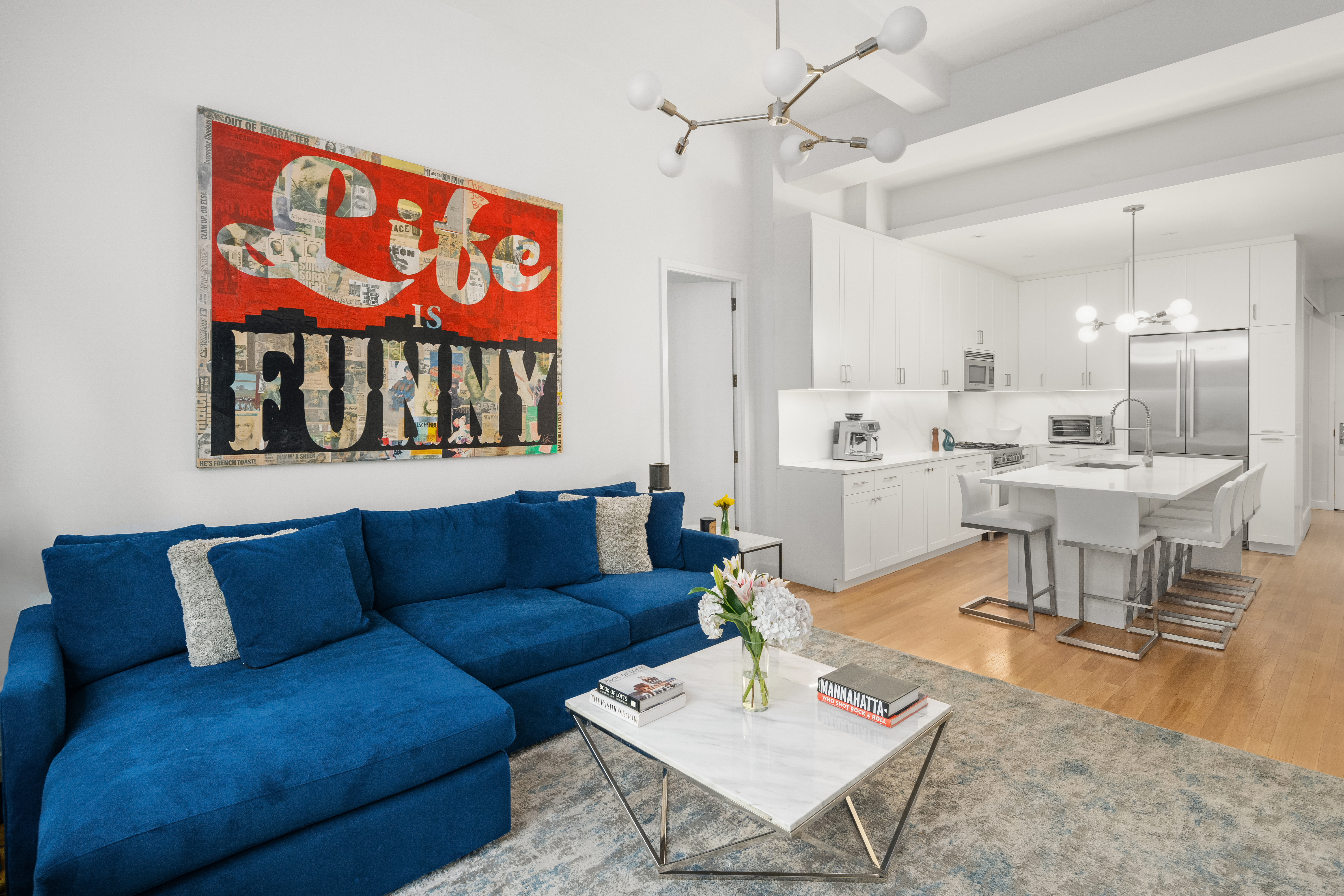 59 John Street, Unit 7D Manhattan, NY 10038 - Photo 4 of 10 a living room with furniture a rug and a painting