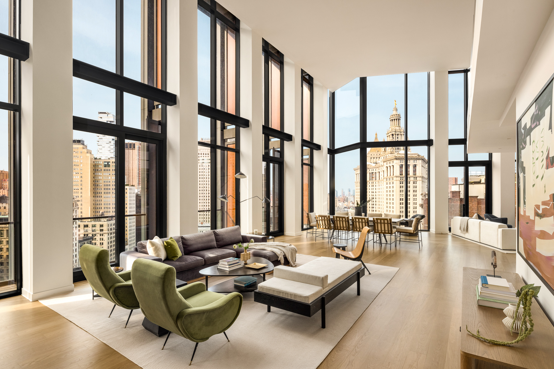 a living room with furniture and floor to ceiling windows