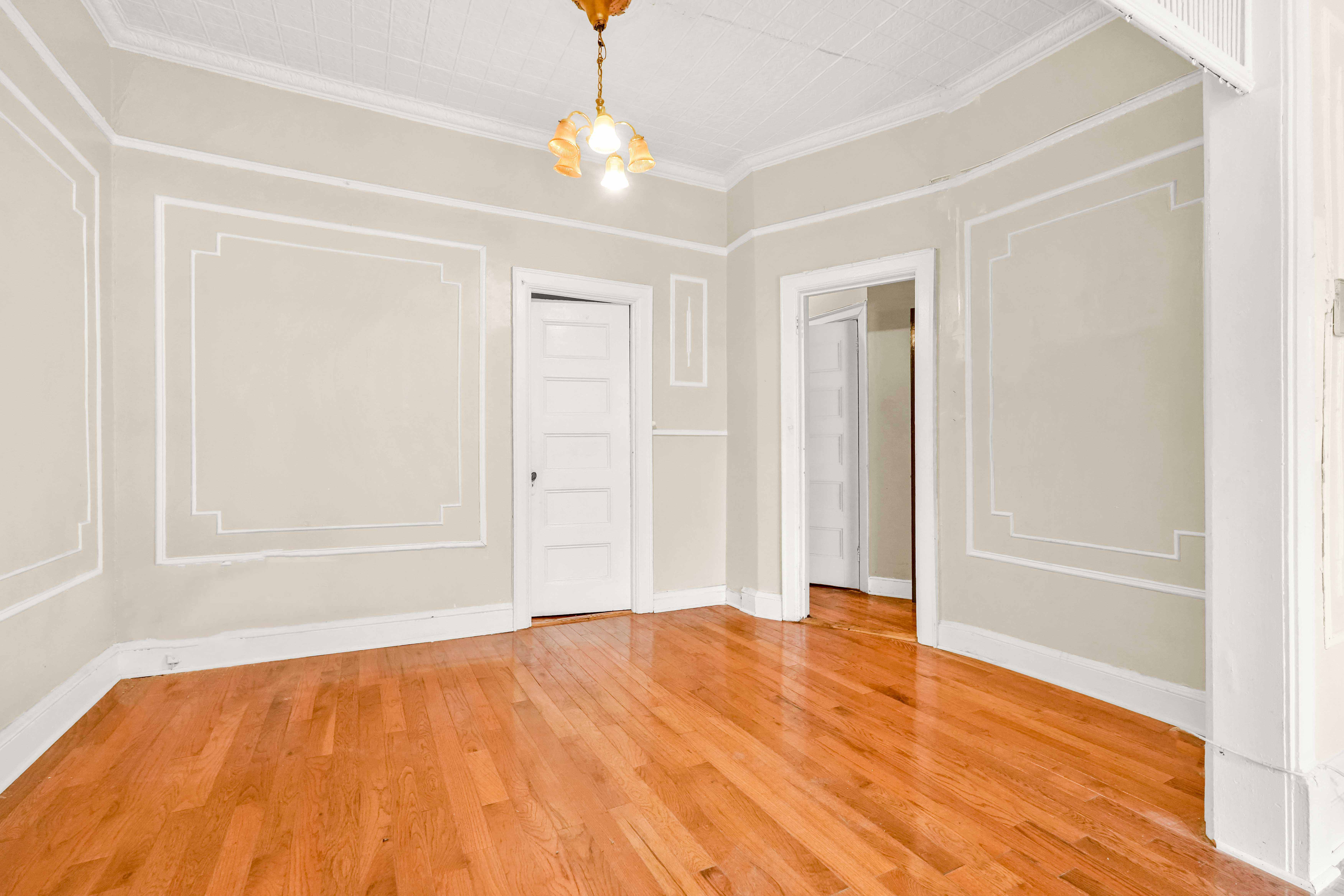 278 Lefferts Avenue Brooklyn, NY 11225 - Photo 25 of 56 a view of an empty room with wooden floor and a window