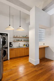 a kitchen with stainless steel appliances granite countertop a sink a stove a refrigerator and wooden floor