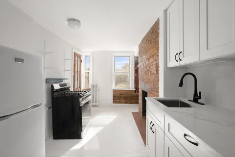 a kitchen with a refrigerator and a sink