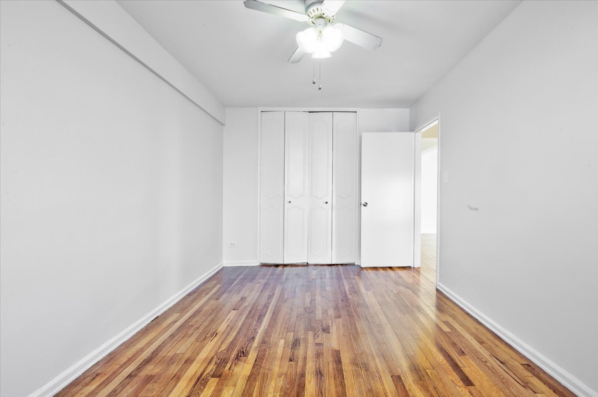 1270 East 51st Street, Unit 6X Brooklyn, NY 11234 - Photo 11 of 17 a view of a room with wooden floor and fan