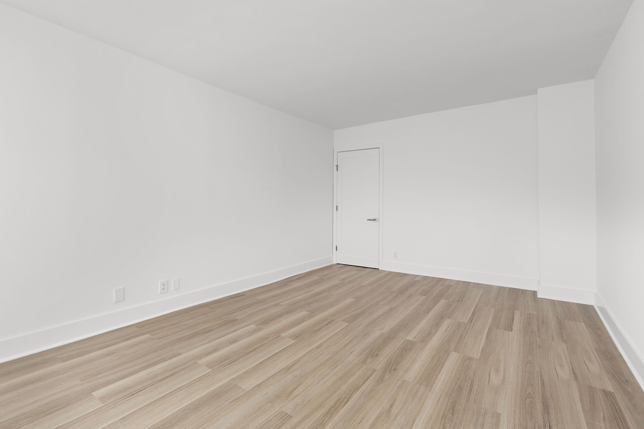 400 East 54th Street, Unit 19H Manhattan, NY 10022 - Photo 6 of 15 a view of empty room with wooden floor