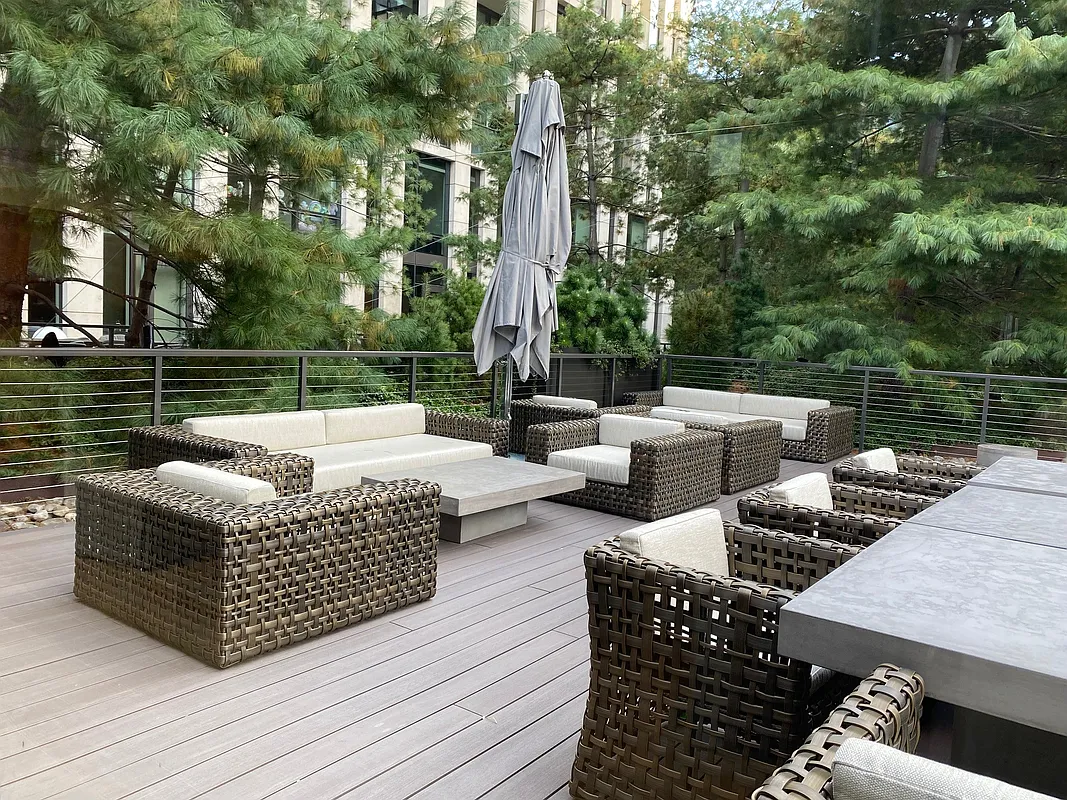 101 Warren Street, Unit 840 Manhattan, NY 10007 - Photo 11 of 16 a patio view with patio couches coffee table and potted plants with large trees