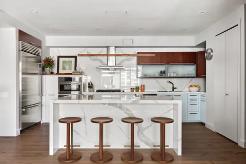 a kitchen with stainless steel appliances a sink and cabinets