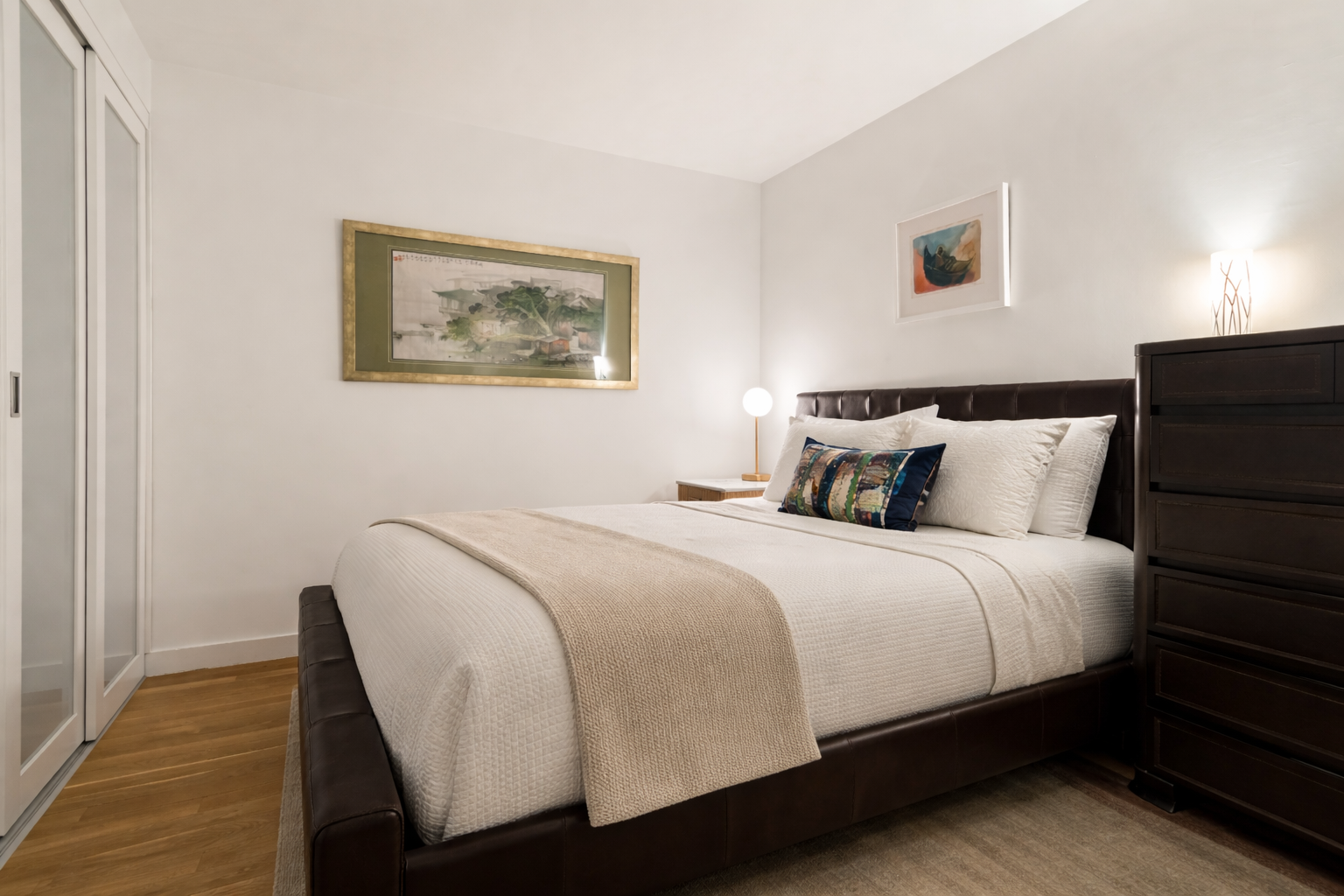 90 William Street, Unit 15F Manhattan, NY 10038 - Photo 4 of 10 a bedroom with a bed and wooden floor
