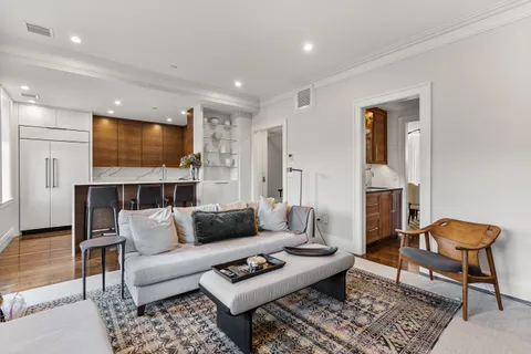 a living room with furniture a rug and a flat screen tv