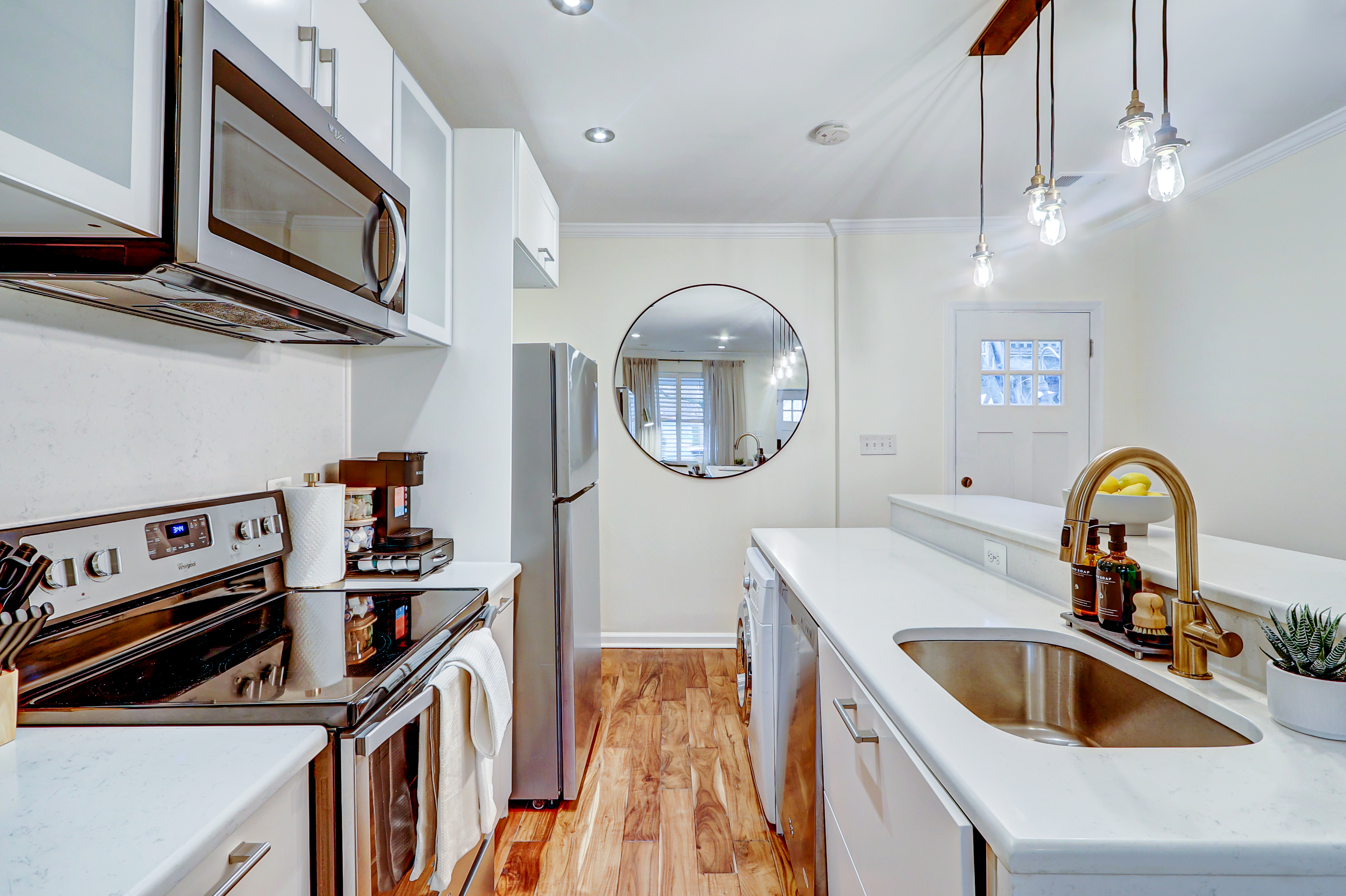 1003 P Street Northwest Washington, DC 20001 - Photo 7 of 34 a kitchen with stainless steel appliances a sink a stove and cabinets