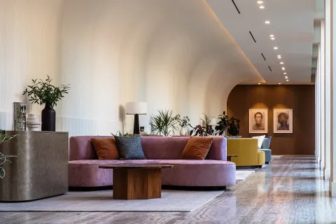 a living room with furniture and a potted plant