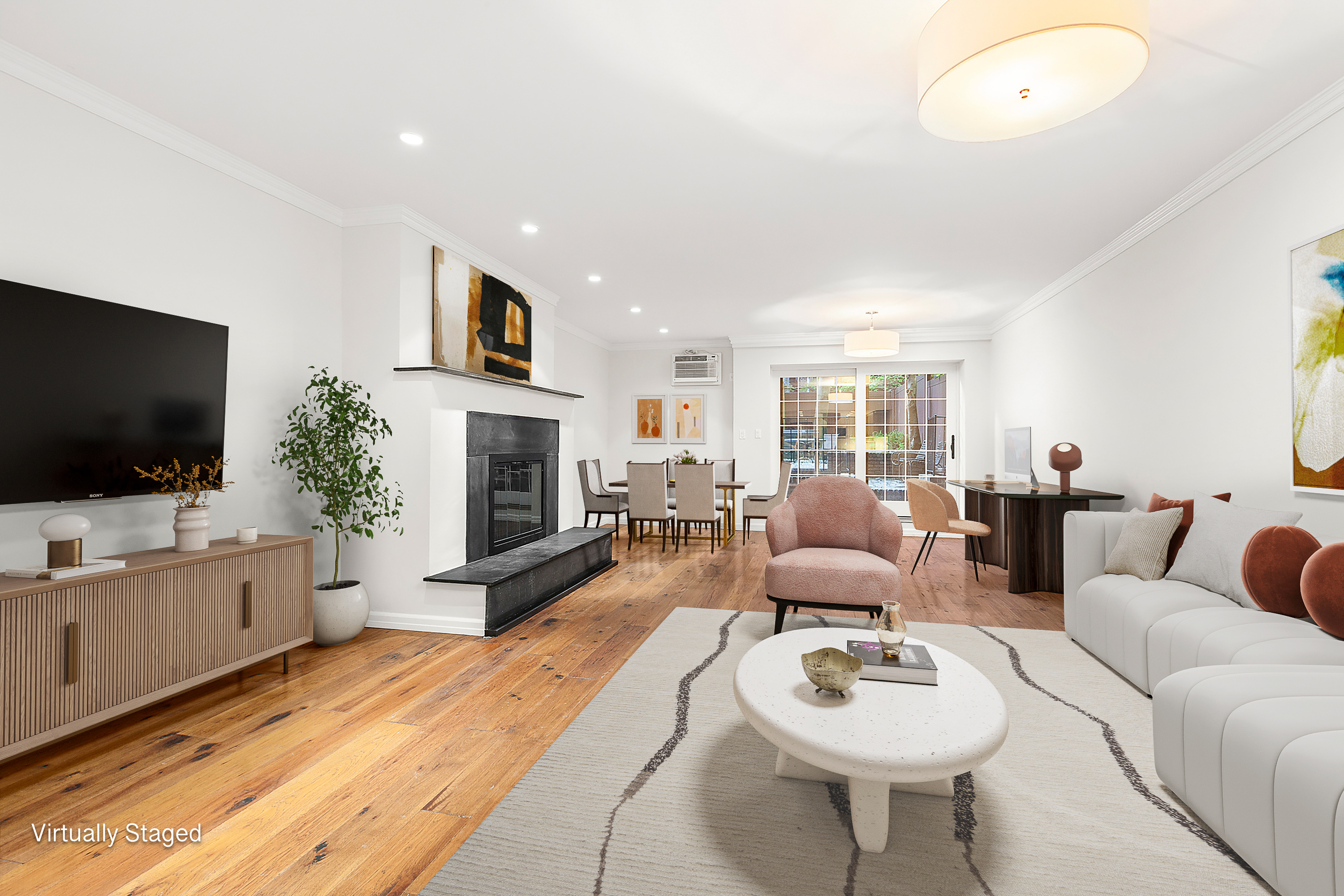 522 East 82nd Street, Unit 1 Manhattan, NY 10028 - Photo 6 of 16 a living room with furniture a flat screen tv and a fireplace