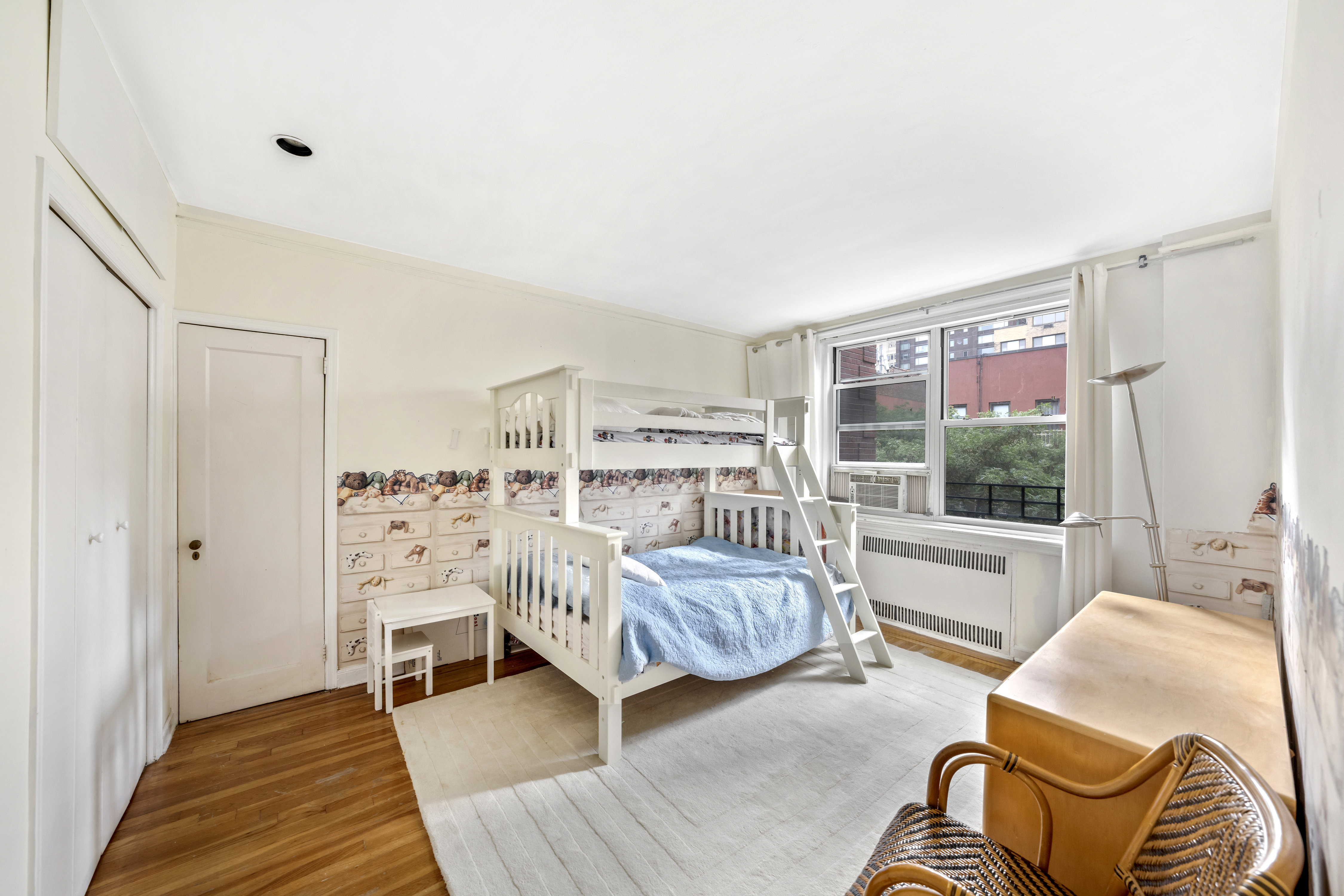 310 West 55th Street, Unit 5G Manhattan, NY 10019 - Photo 5 of 7 a bedroom with furniture and a window