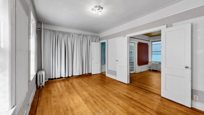 860 56th Street Brooklyn, NY 11220 - Photo 2 of 6 a view of a livingroom with wooden floor and a bathroom