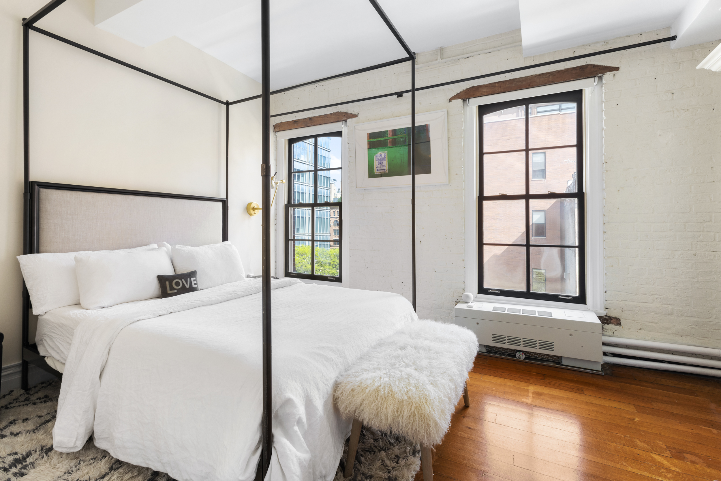 62 Beach Street, Unit 5E Manhattan, NY 10013 - Photo 11 of 15 a bedroom with a bed and a large window