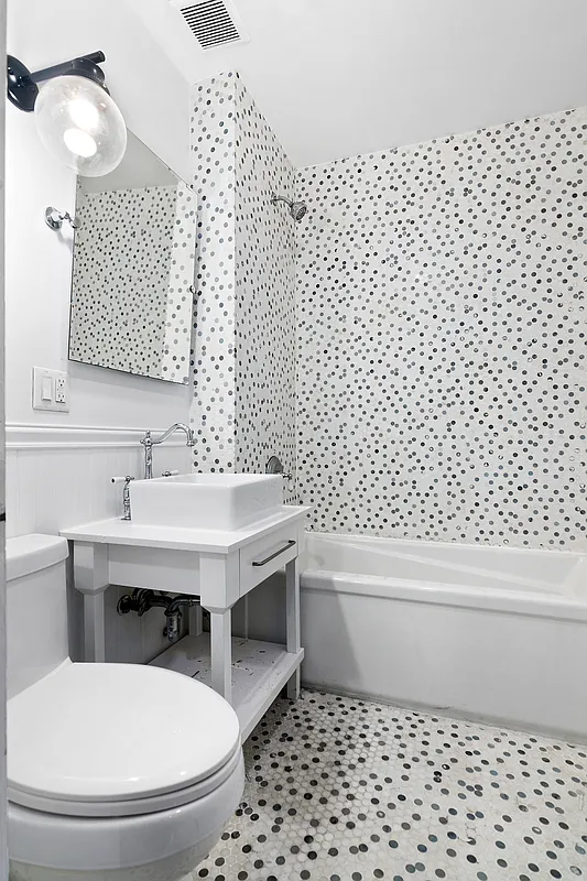 180 Bainbridge Street, Unit 211 Brooklyn, NY 11233 - Photo 7 of 21 a bathroom with a sink a toilet and a mirror