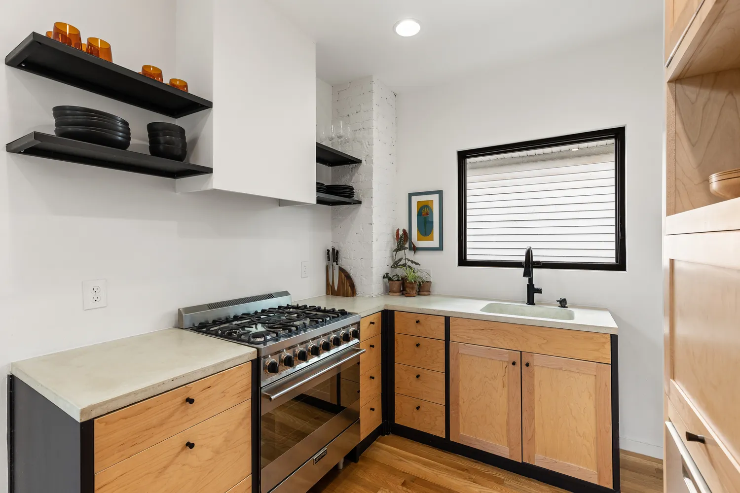 a kitchen with stainless steel appliances a sink stove and microwave