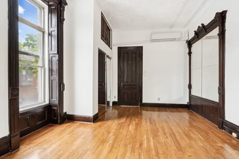 a view of a room with wooden floor and a balcony