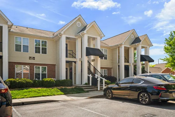 a front view of a residential apartment building with a yard