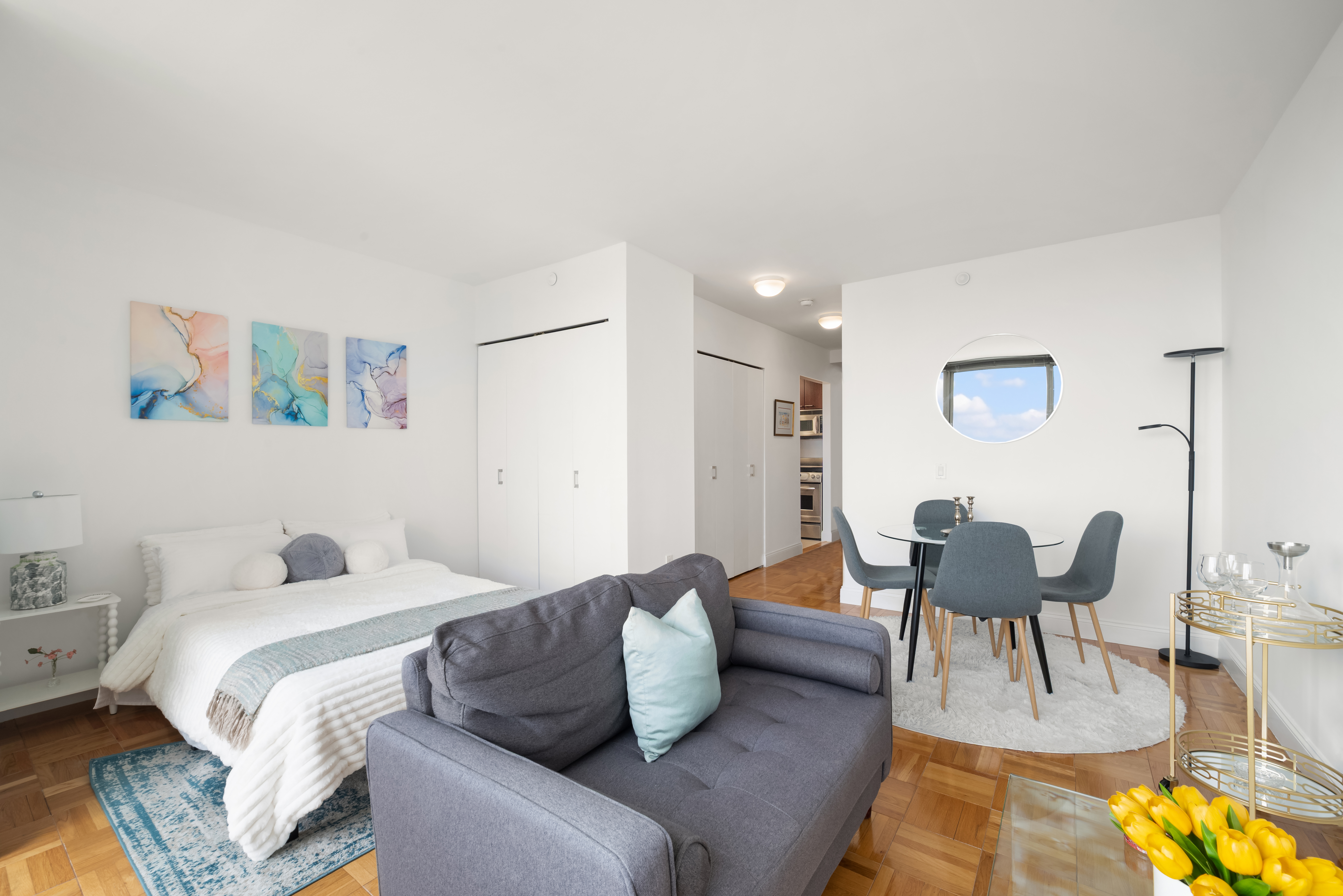 215-217 East 96th Street, Unit 25B Manhattan, NY 10128 - Photo 3 of 19 a bedroom with a bed and a couch