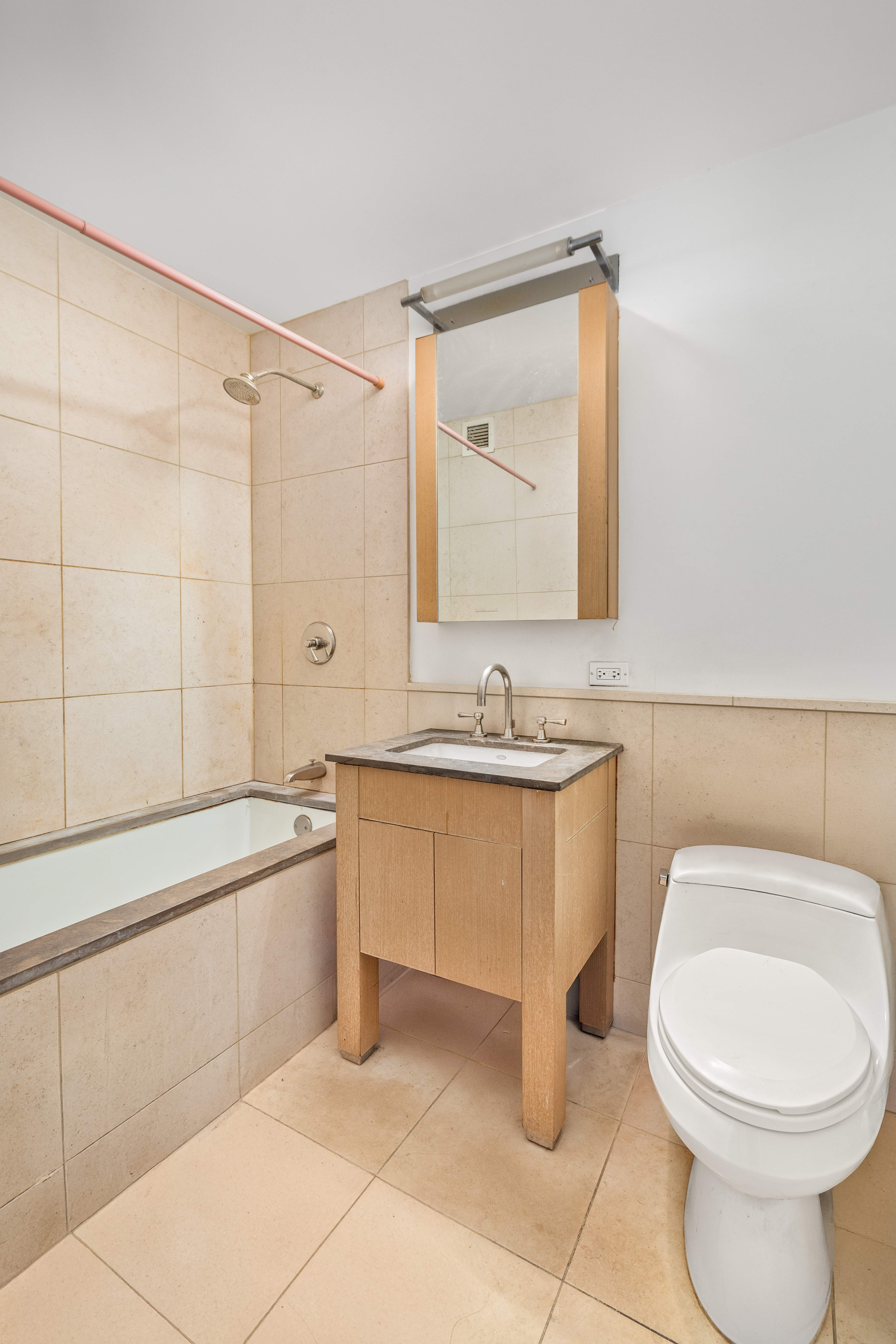 350 West 42nd Street, Unit 5D Manhattan, NY 10036 - Photo 4 of 13 a bathroom with a toilet sink and mirror