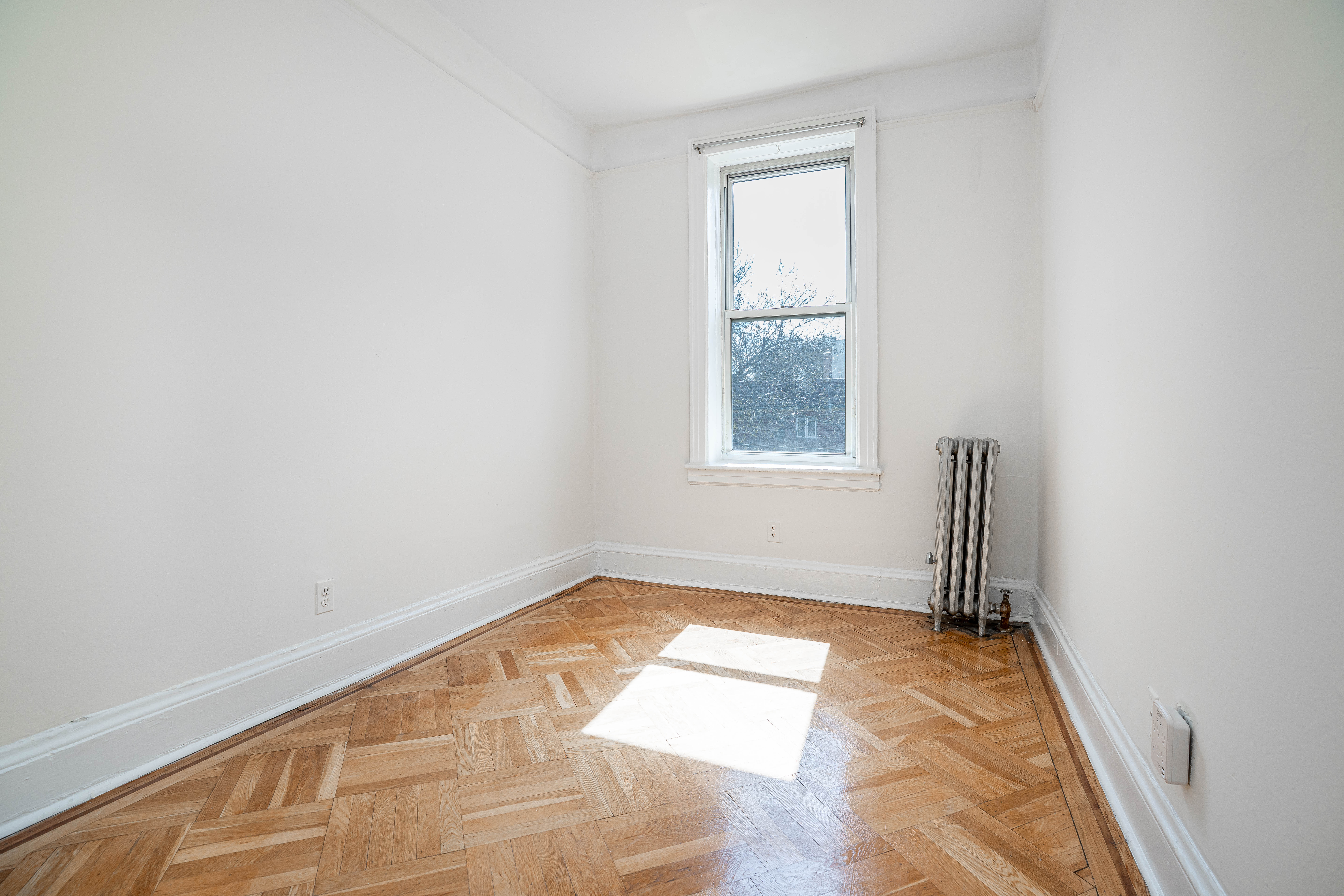 27-15 24th Avenue, Unit 2 Queens, NY 11105 - Photo 5 of 10 an empty room with windows