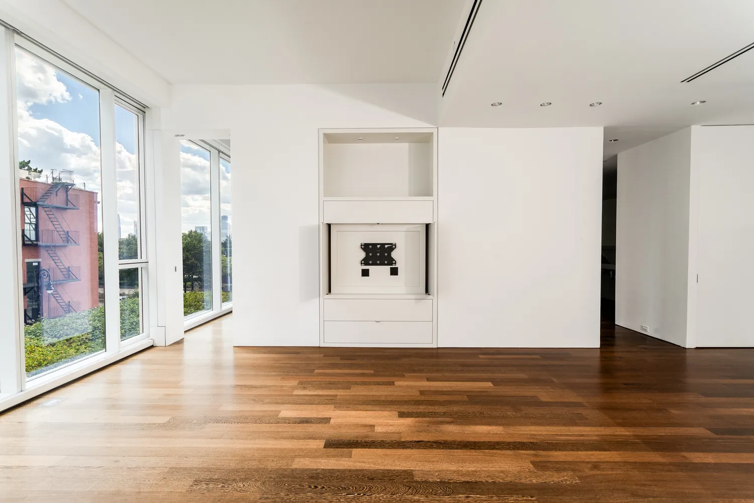 a view of a room with wooden floor and a window