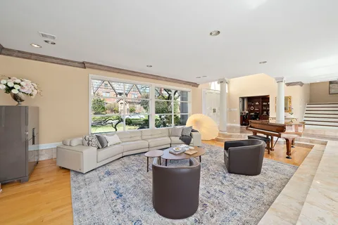 a living room with fireplace furniture and a large window