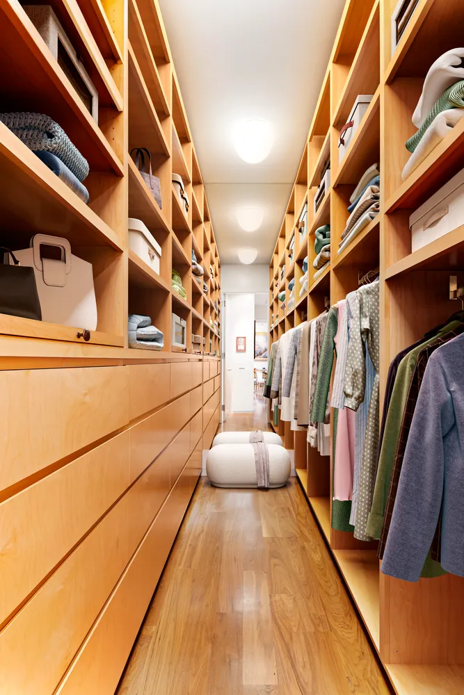 a view of walk in closet with clothes and shoes