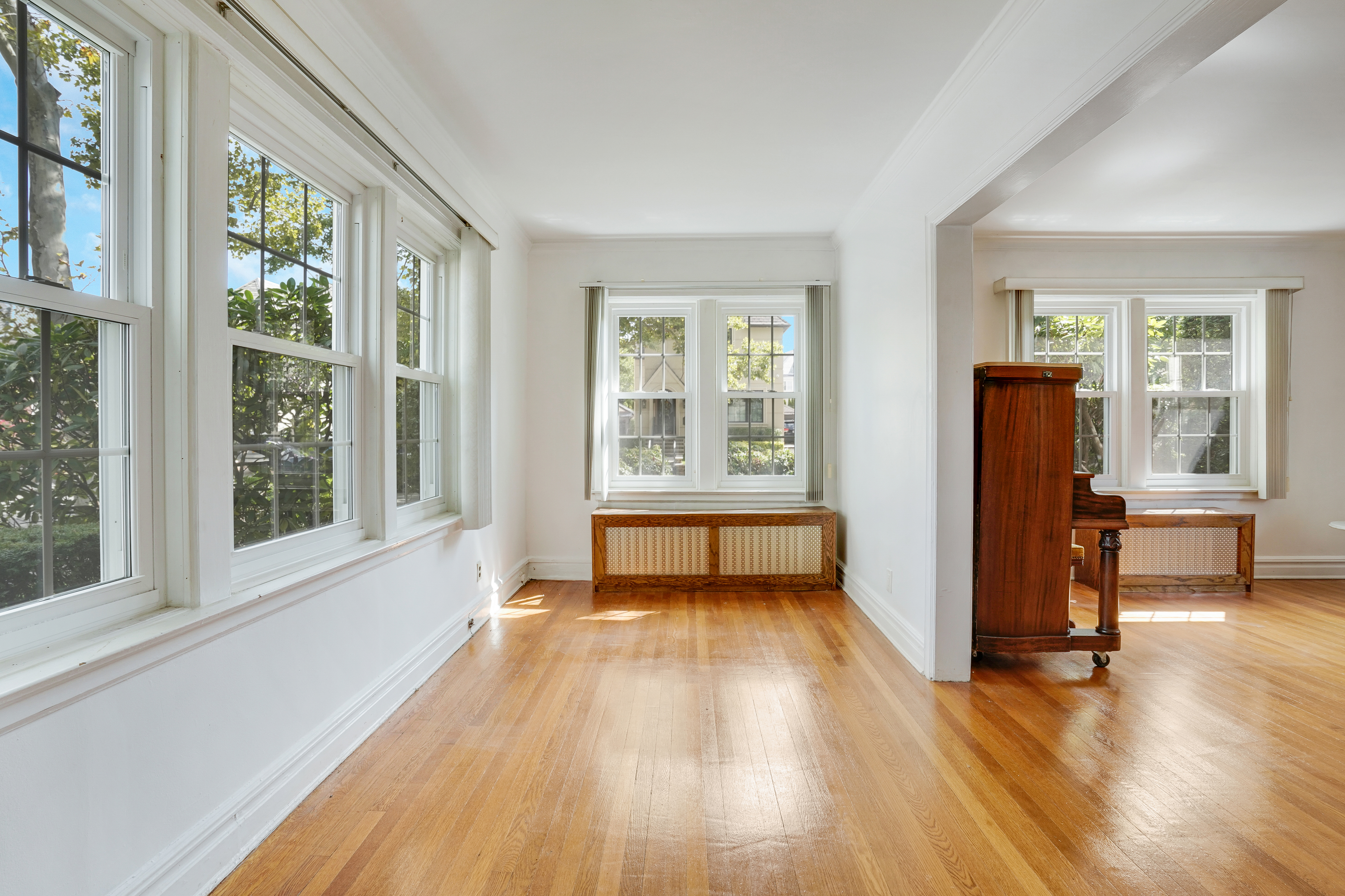 8028 Harbor View Terrace Brooklyn, NY 11209 - Photo 3 of 16 wooden floor in an empty room with a window