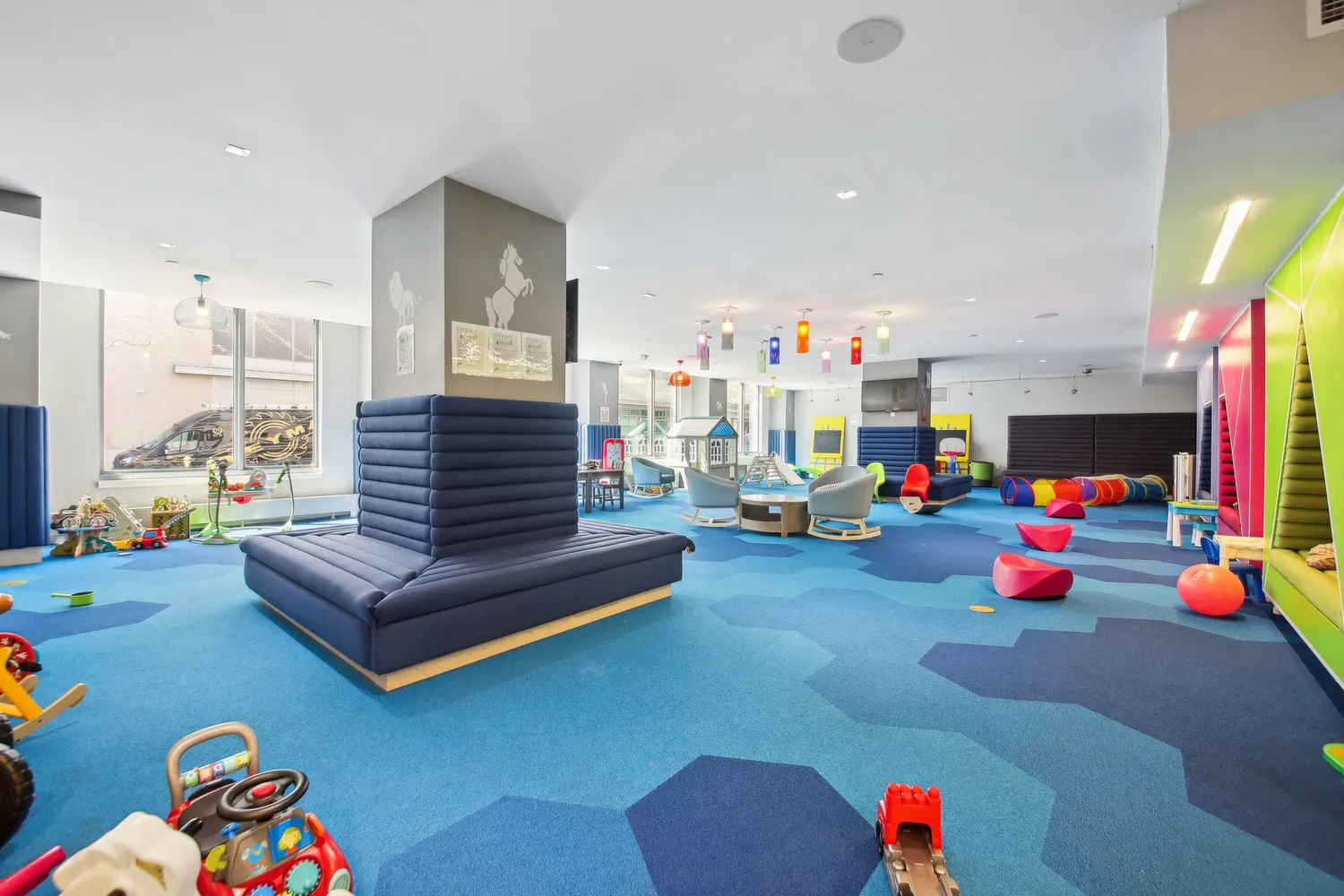 a living room with lots of furniture and toys