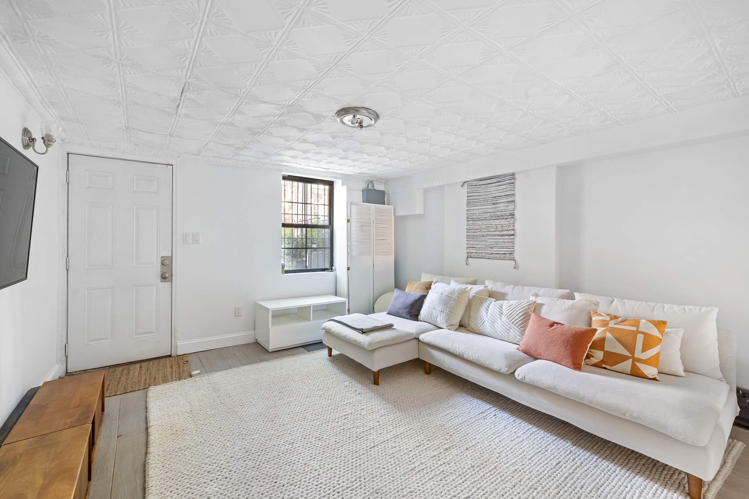 716 Monroe Street Brooklyn, NY 11221 - Photo 17 of 22 a living room with furniture and a large window