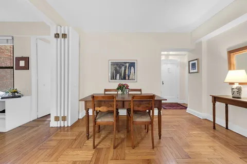 a view of a dining room with furniture and wooden floor