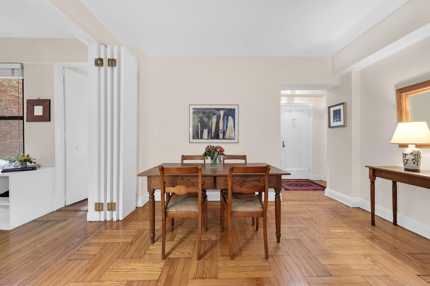 151 East 83rd Street, Unit 2E Manhattan, NY 10028 - Photo 3 of 12 a view of a dining room with furniture and wooden floor