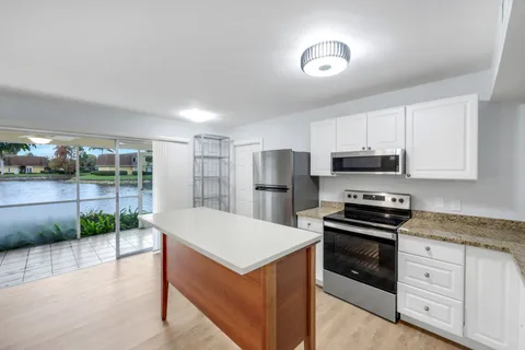 a kitchen with stainless steel appliances a refrigerator and a stove top oven