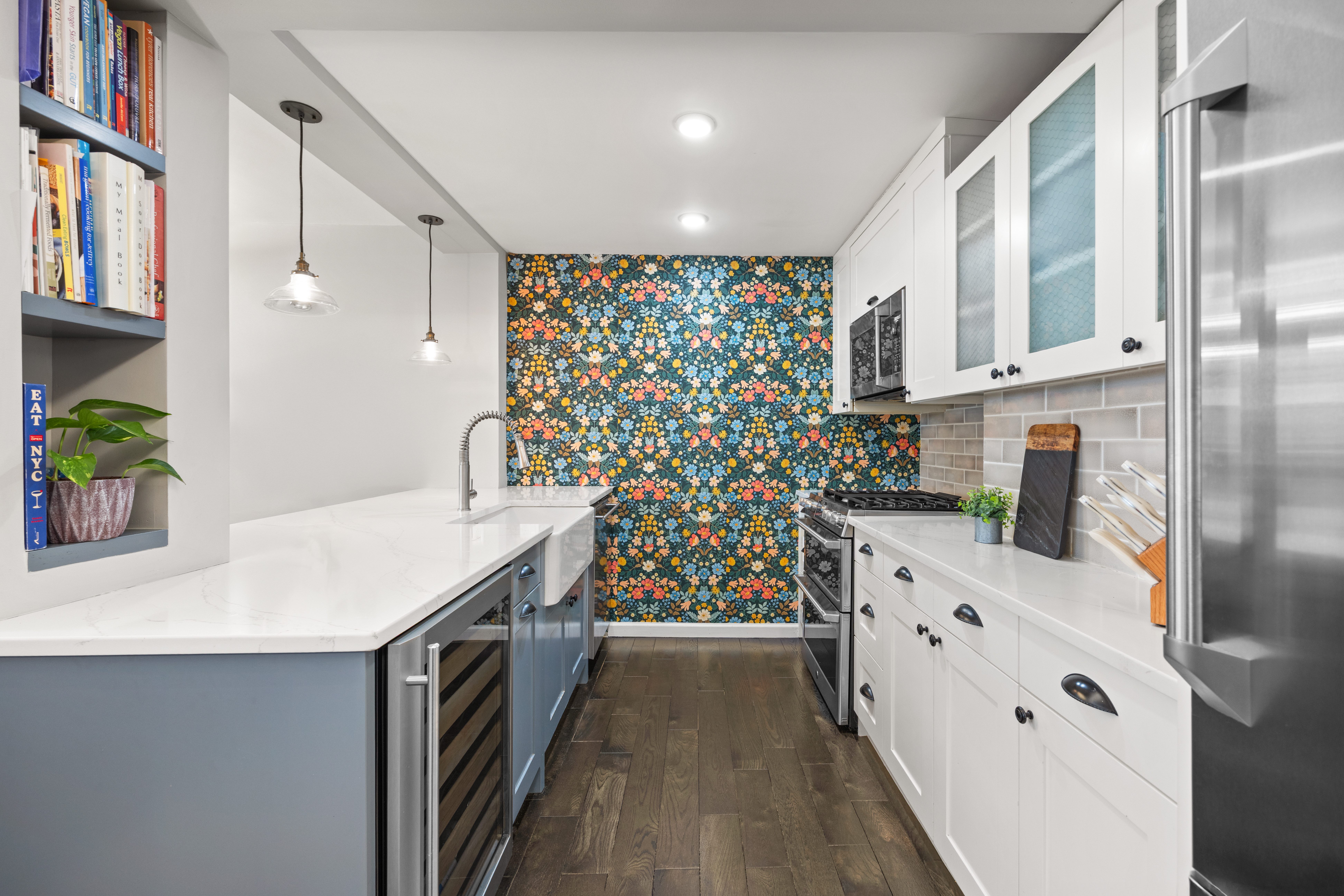 345 East 56th Street, Unit 3F Manhattan, NY 10022 - Photo 3 of 10 a kitchen with stainless steel appliances a stove and a wooden floor