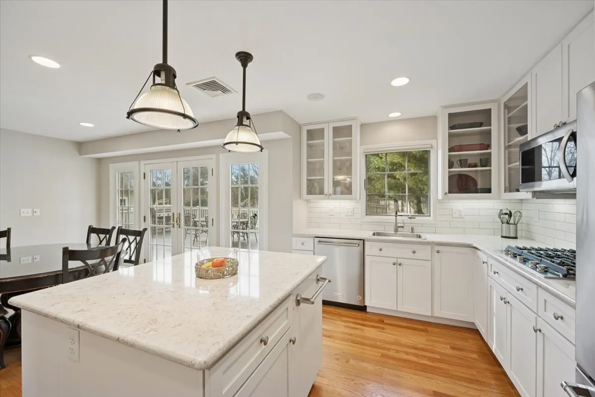 a kitchen with stainless steel appliances a stove refrigerator sink and cabinets