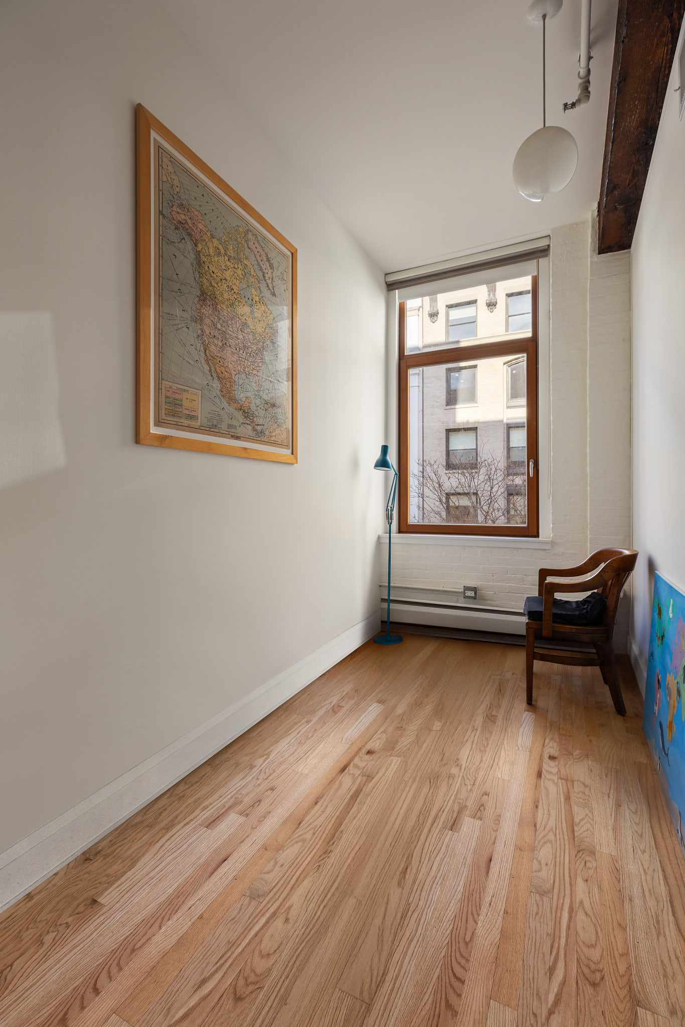 124 West 24th Street, Unit 4A Manhattan, NY 10011 - Photo 8 of 13 a view of a room with wooden floor and window