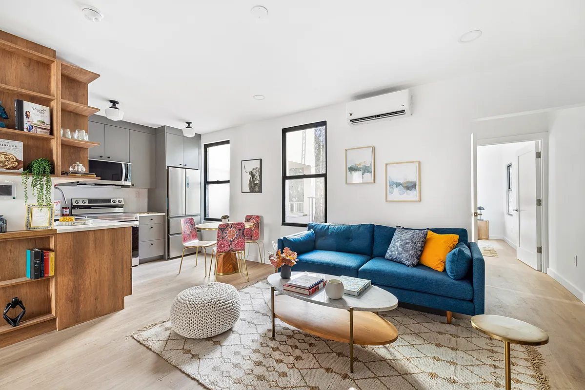 76 Meserole Avenue, Unit 2A Brooklyn, NY 11222 - Photo 2 of 10 a living room with furniture and a rug
